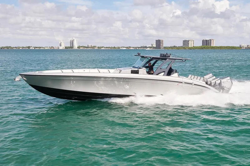 Slide: The Image of 2022 Midnight Express 43 Open boat cruising on clear blue water. - 1