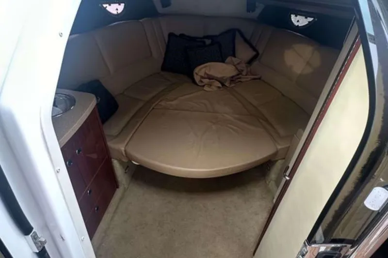Slide: The Image of Interior cabin of a 2008 Cobalt 323 boat with beige seating and compact kitchenette. - 11