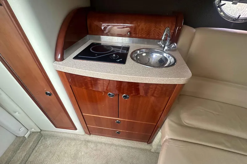 Slide: The Image of Compact kitchenette in 2008 Cobalt 323 boat with sink and stove. - 12