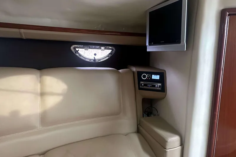 Slide: The Image of Interior of a 2008 Cobalt 323 boat with beige seating and a mounted TV. - 17