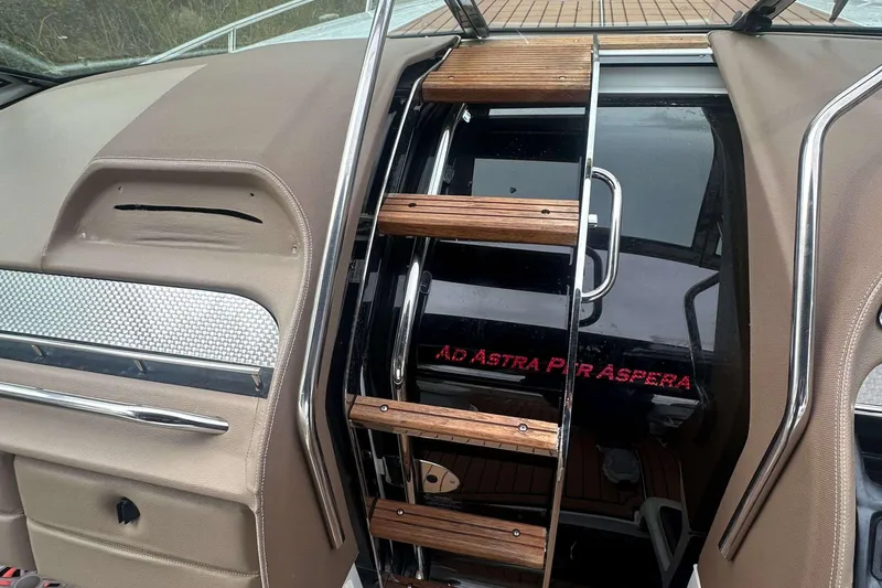 Slide: The Image of Interior of a 2008 Cobalt 323 boat with wooden ladder and "Ad Astra Per Aspera" text. - 18