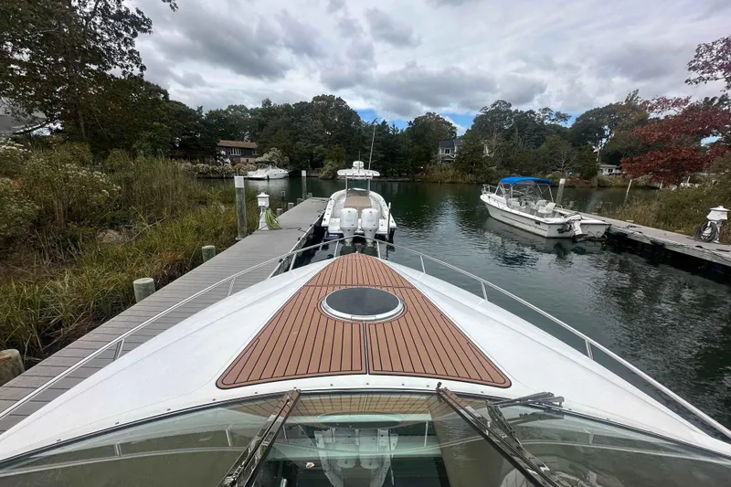 Slide: The Image of Bow view of a 2008 Cobalt 323 boat docked in a serene marina. - 19