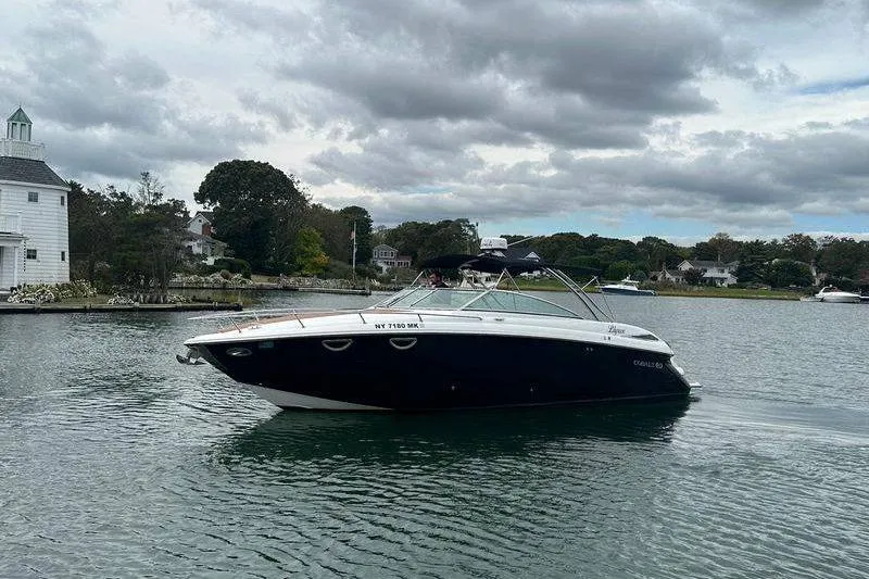 Slide: The Image of 2008 Cobalt 323 boat cruising on a calm lake under cloudy skies. - 2