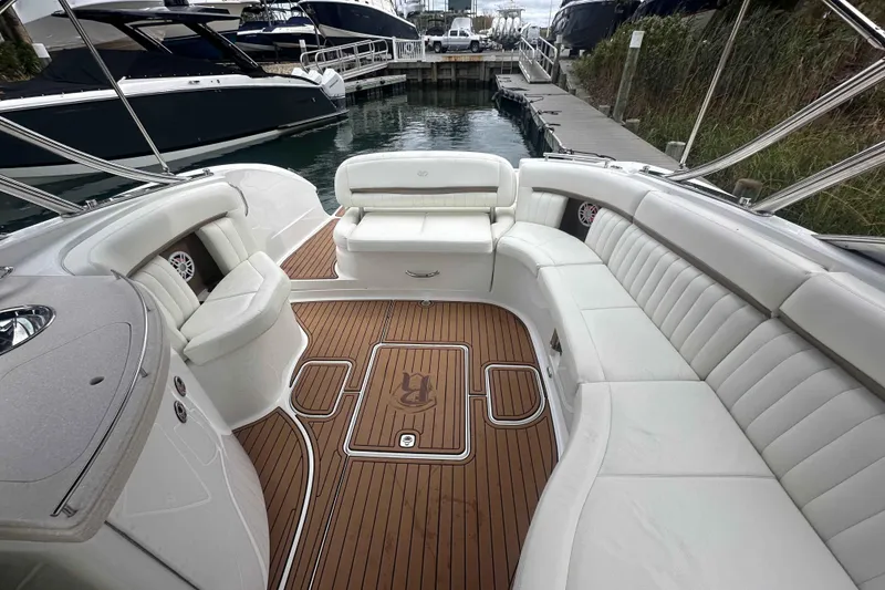 Slide: The Image of Luxurious 2008 Cobalt 323 boat interior with white seating and teak flooring at a marina. - 8
