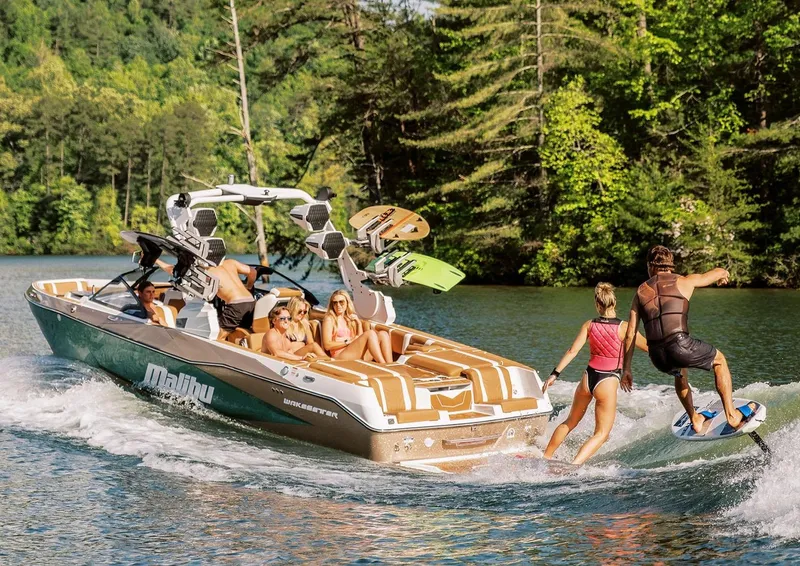 Slide: The Image of Manufacturer Provided Image: 2026 Malibu Wakesetter 25 LSV on a lake, people enjoying wakeboarding and leisure. - 12