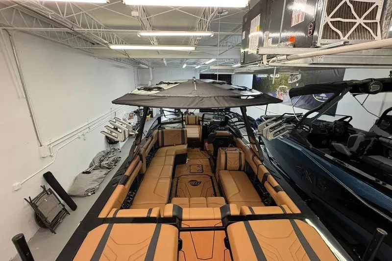 Slide: The Image of 2026 Malibu Wakesetter 25 LSV boat with tan seating in a showroom. - 6