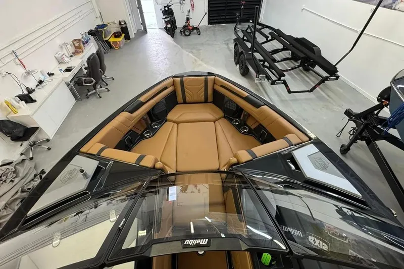 Slide: The Image of 2026 Malibu Wakesetter 25 LSV interior with tan seating in a workshop setting. - 8