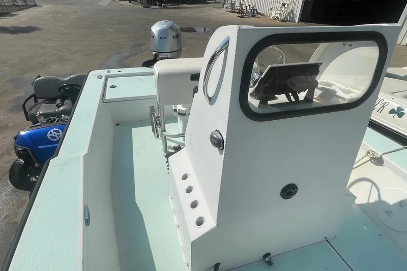 Slide: The Image of 2014 Lifetyme 2070 boat with Honda outboard motor, parked near a blue golf cart. - 6