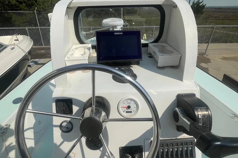Slide: The Image of Boat dashboard with steering wheel, navigation screen, and controls, Lifetyme 2070, 2014 model. - 7