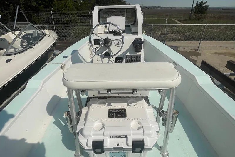 Slide: The Image of Open deck of a 2014 Lifetyme 2070 boat with steering console and Pelican cooler. - 8