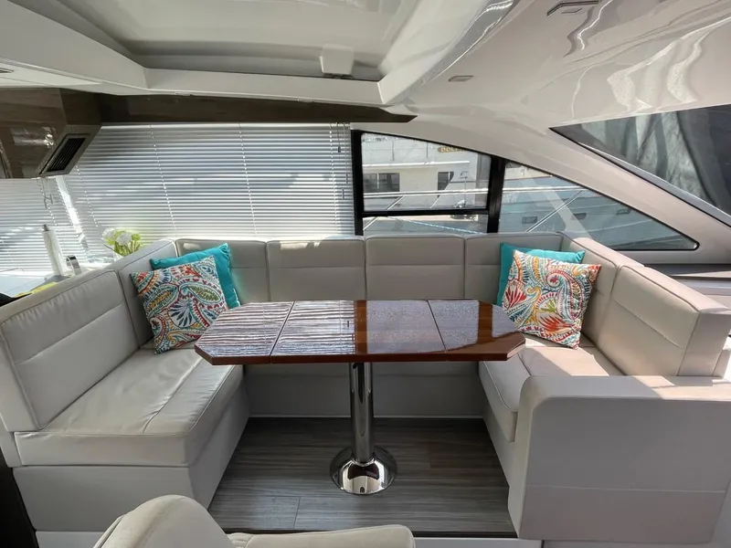 Slide: The Image of Luxurious 2019 Cruisers 50 Cantius yacht interior with elegant seating and decorative pillows. - 14