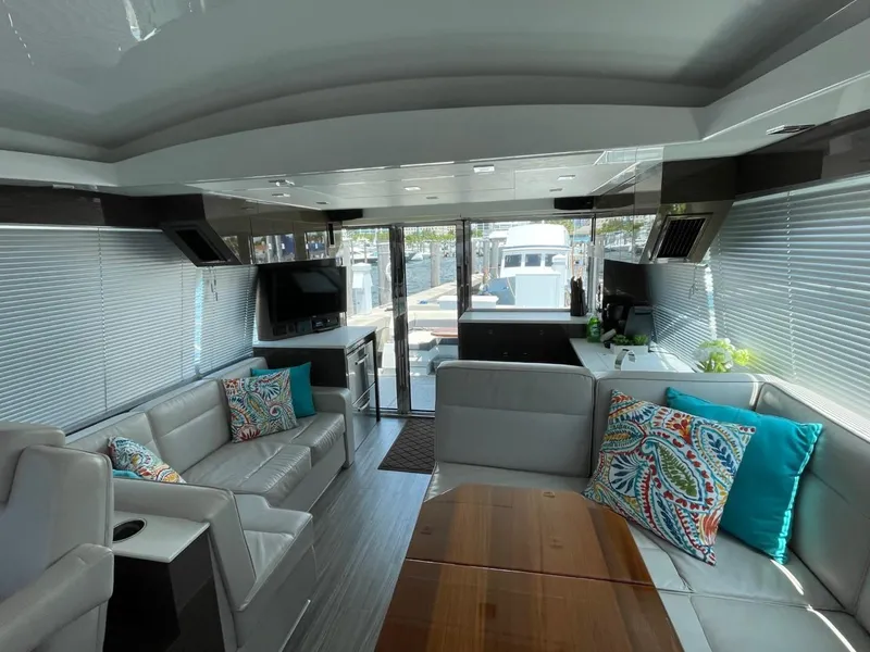 Slide: The Image of Luxurious interior of 2019 Cruisers 50 Cantius yacht with modern seating and vibrant cushions. - 16