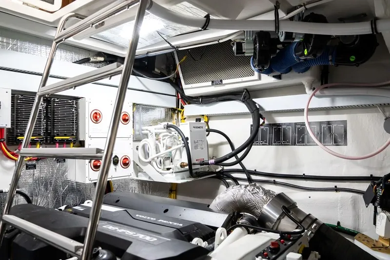 Slide: The Image of Engine room of 2019 Cruisers 50 Cantius yacht, featuring modern equipment and wiring. - 25