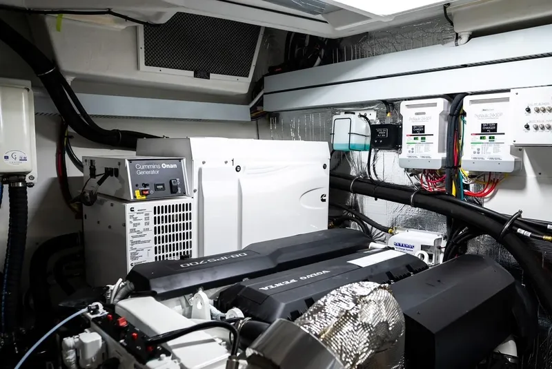 Slide: The Image of Engine room of 2019 Cruisers 50 Cantius yacht, featuring generator and electrical systems. - 26