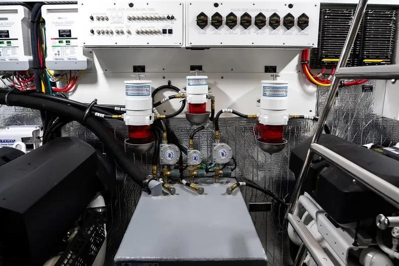 Slide: The Image of Engine room of 2019 Cruisers 50 Cantius yacht, featuring control panels and fuel filters. - 27