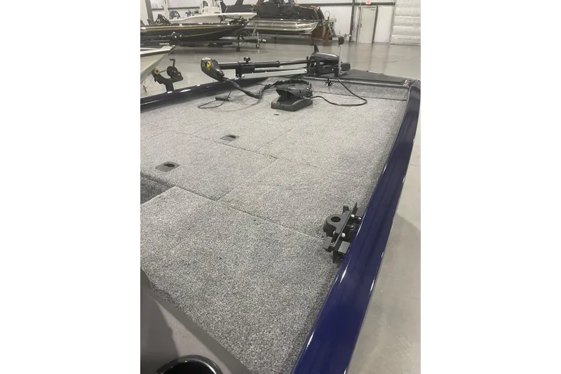 Slide: The Image of 2021 Tracker Pro 170 boat interior with carpeted deck and mounted equipment. - 27