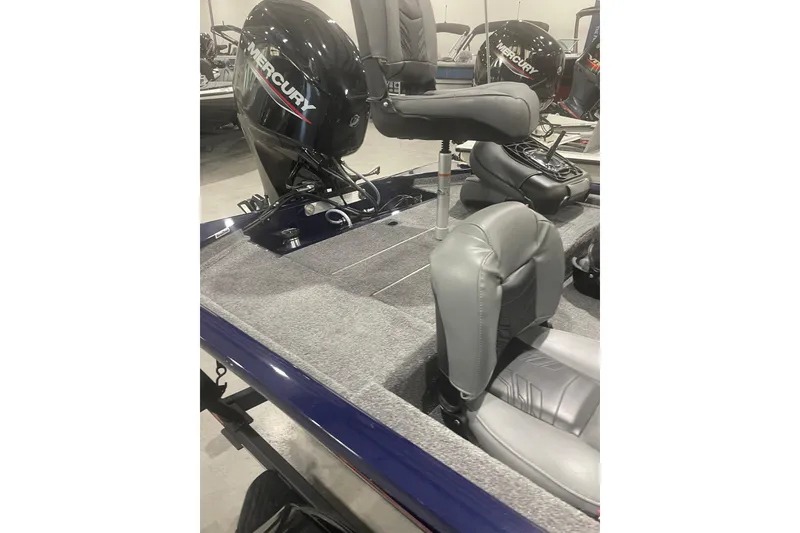 Slide: The Image of 2021 Tracker Pro 170 boat interior with Mercury engine and gray seating. - 29