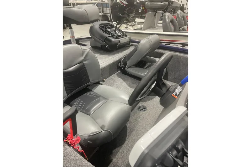 Slide: The Image of 2021 Tracker Pro 170 boat interior with gray seating and steering wheel. - 30