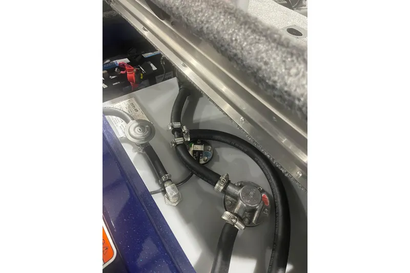 Slide: The Image of 2021 Tracker Pro 170 boat engine compartment with hoses and connectors. - 32