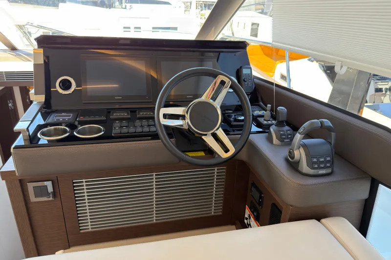 Slide: The Image of Prestige 520 yacht helm, 2023 model, featuring modern electronics. - 15