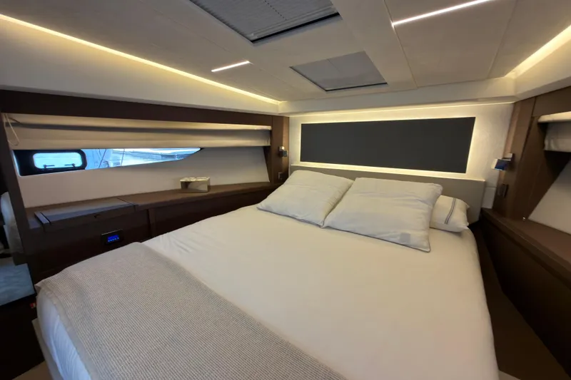 Slide: The Image of Luxurious bedroom interior of 2023 Prestige 520 yacht with modern lighting and elegant bedding. - 16
