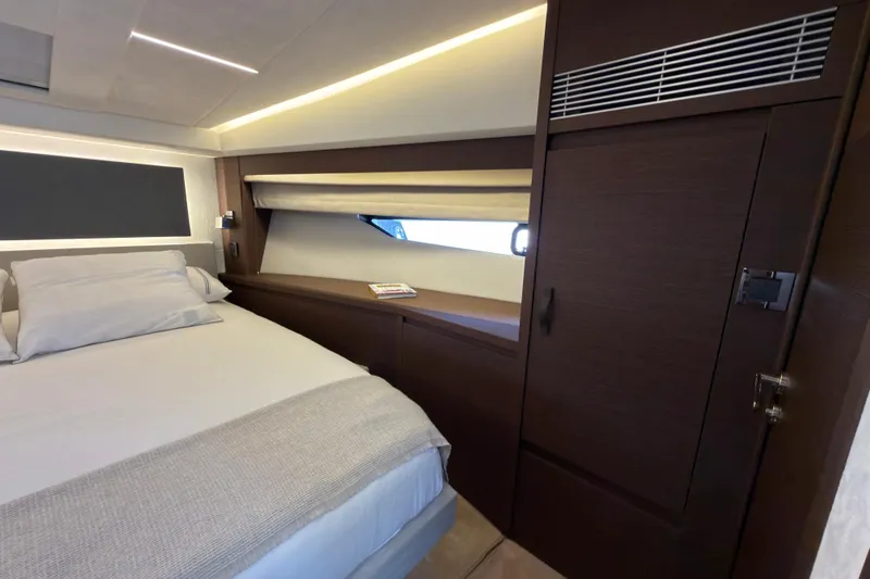 Slide: The Image of Luxurious 2023 Prestige 520 yacht interior with elegant bedroom design and modern wood finishes. - 17