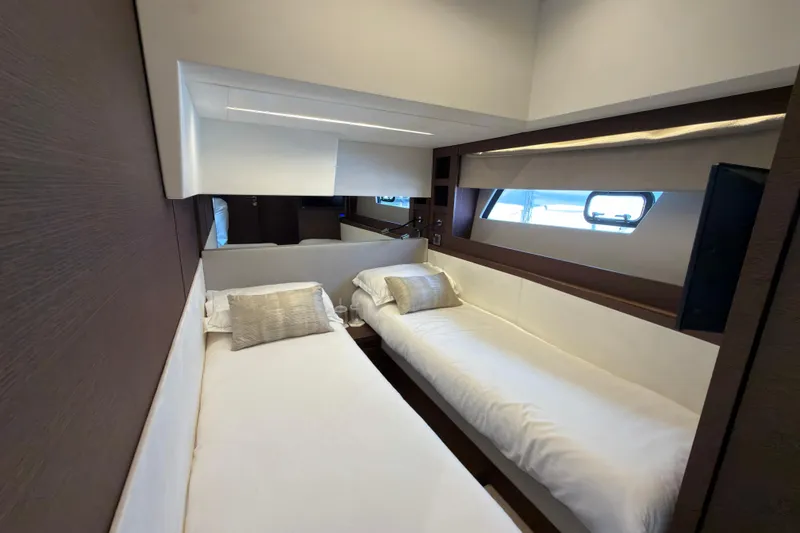 Slide: The Image of Luxurious twin cabin interior on 2023 Prestige 520 yacht, featuring modern design and comfortable bedding. - 18