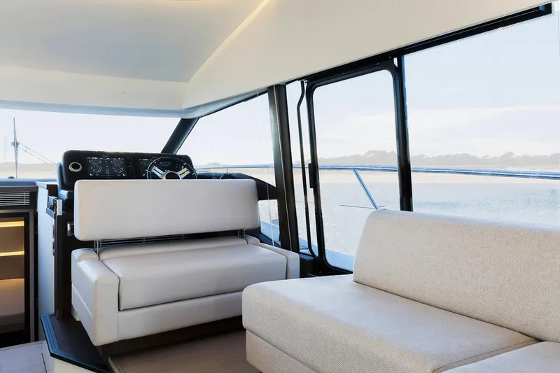 Slide: The Image of Manufacturer Provided Image: Interior of 2023 Prestige 520 yacht with modern seating and panoramic windows. - 21