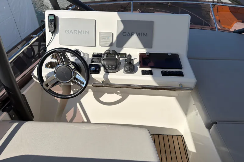 Slide: The Image of Cockpit of 2023 Prestige 520 yacht with Garmin navigation system and controls. - 23