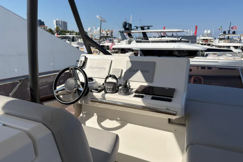 Slide: The Image of Helm of 2023 Prestige 520 yacht with Garmin navigation system, docked at marina. - 24