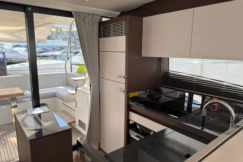 Slide: The Image of Modern kitchen interior on 2023 Prestige 520 yacht, featuring sleek cabinetry and elegant design. - 8