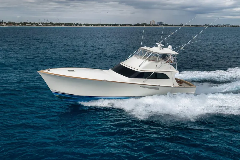The Image of 1999 Hines-Farley SPORTFISHERMAN yacht cruising on open ocean under cloudy skies. - 0