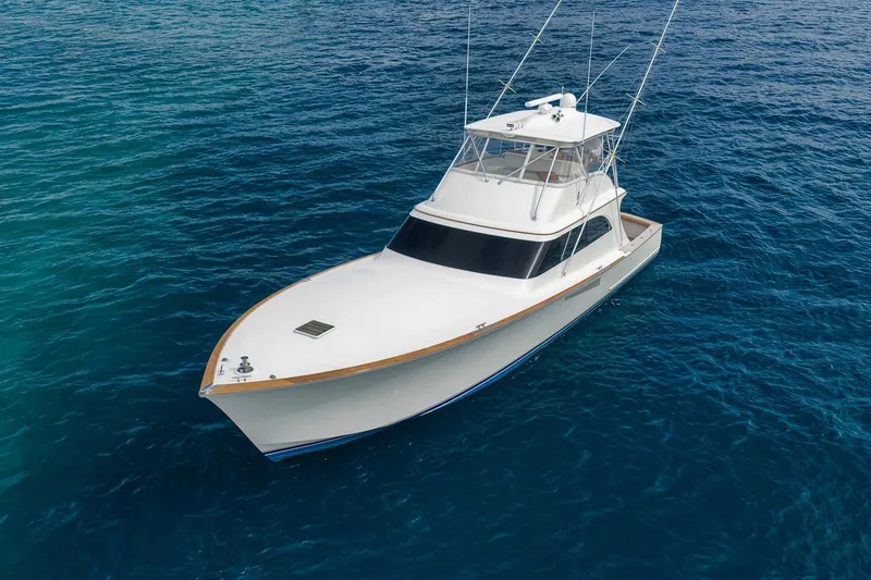 Slide: The Image of 1999 Hines-Farley SPORTFISHERMAN yacht on clear blue ocean waters. - 14