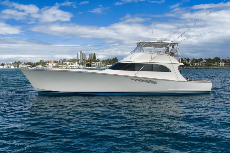 Slide: The Image of 1999 Hines-Farley SPORTFISHERMAN yacht on blue ocean with city skyline background. - 15