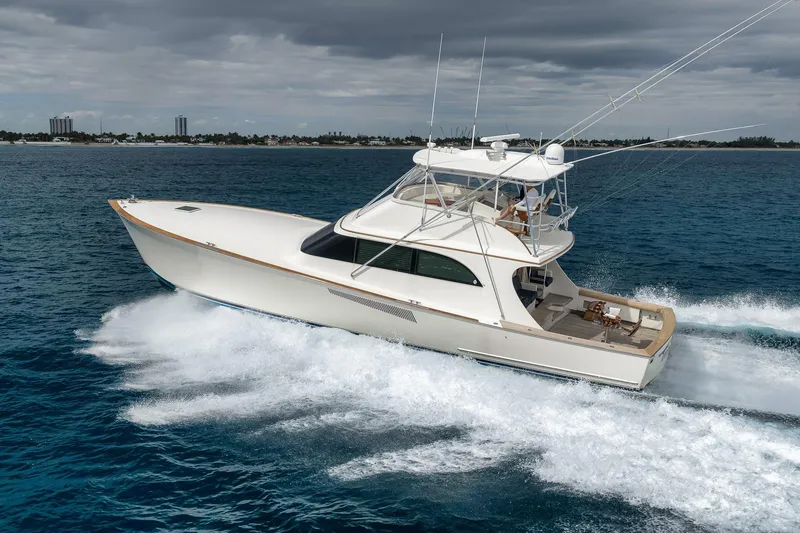 Slide: The Image of 1999 Hines-Farley SPORTFISHERMAN yacht cruising on open water under cloudy skies. - 17