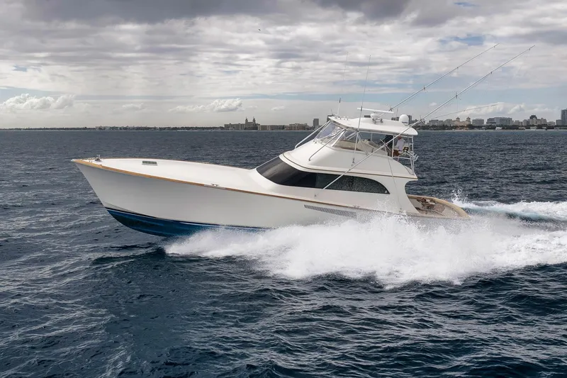 Slide: The Image of 1999 Hines-Farley SPORTFISHERMAN yacht cruising on open water under cloudy skies. - 18