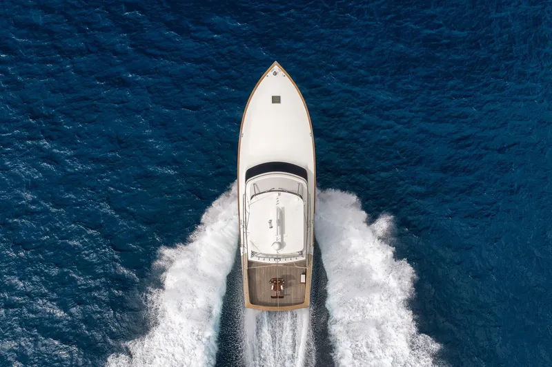 Slide: The Image of Overhead view of 1999 Hines-Farley SPORTFISHERMAN yacht cruising through blue ocean waters. - 20