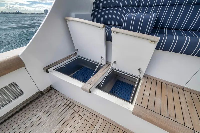 Slide: The Image of 1999 Hines-Farley SPORTFISHERMAN boat with open storage compartments and striped seating. - 35