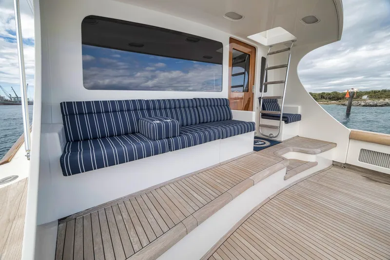 Slide: The Image of 1999 Hines-Farley SPORTFISHERMAN yacht deck with striped seating and ocean view. - 41