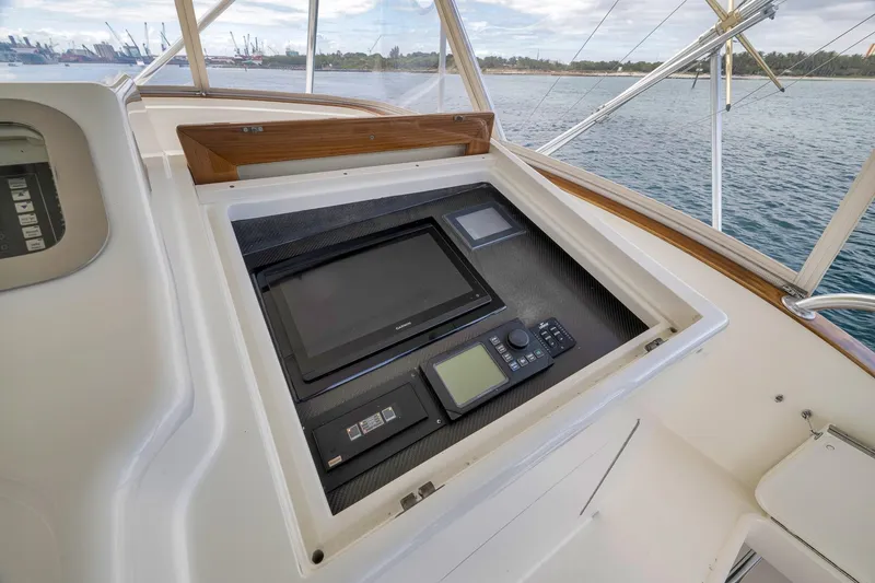 Slide: The Image of 1999 Hines-Farley SPORTFISHERMAN helm with navigation equipment, overlooking serene waters. - 46