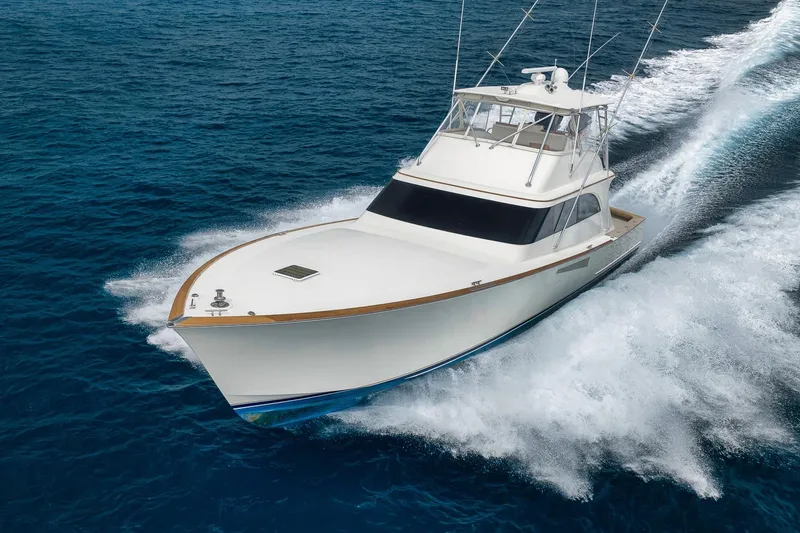 Slide: The Image of 1999 Hines-Farley SPORTFISHERMAN yacht cruising on open blue sea. - 5