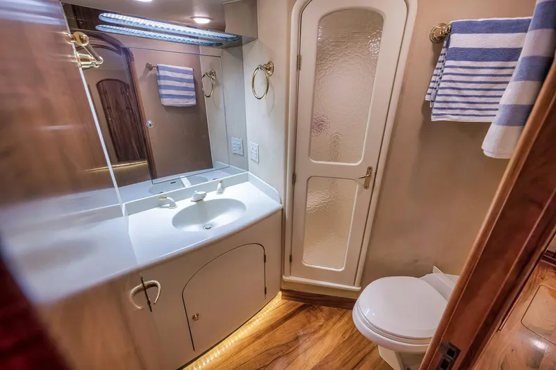 Slide: The Image of Luxurious 1999 Hines-Farley SPORTFISHERMAN yacht bathroom with elegant fixtures and striped towels. - 51