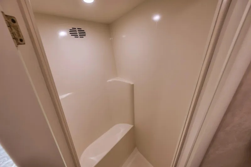 Slide: The Image of 1999 Hines-Farley SPORTFISHERMAN shower interior with beige walls and built-in seat. - 53
