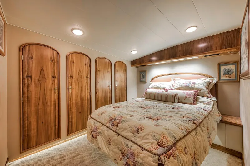 Slide: The Image of Luxurious bedroom interior of 1999 Hines-Farley SPORTFISHERMAN yacht with wood accents and cozy bedding. - 54