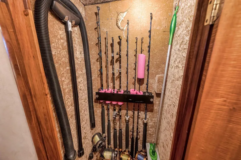 Slide: The Image of Fishing rods stored in a 1999 Hines-Farley SPORTFISHERMAN boat compartment. - 62