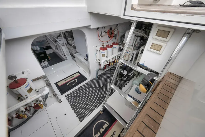 Slide: The Image of Engine room of a 1999 Hines-Farley SPORTFISHERMAN, featuring equipment and access ladder. - 65