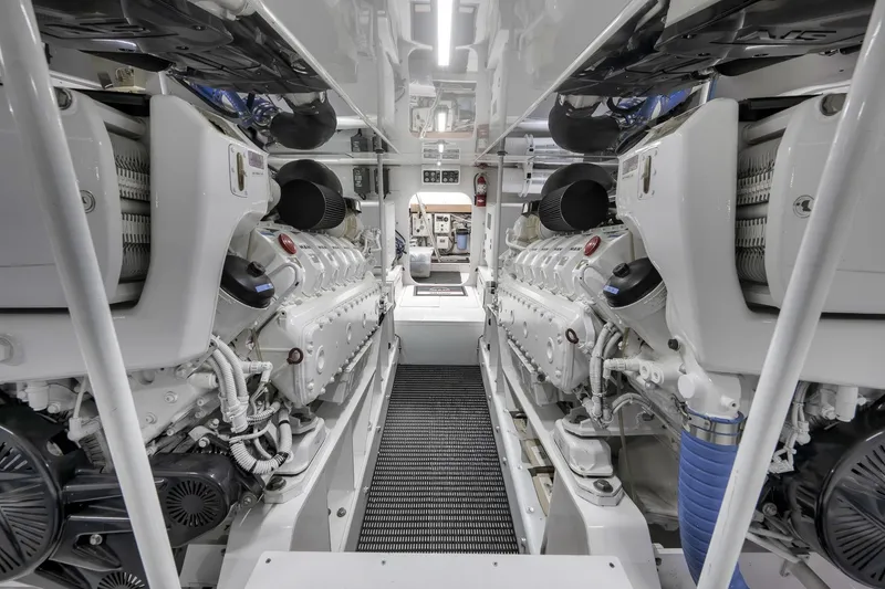 Slide: The Image of Engine room of 1999 Hines-Farley SPORTFISHERMAN yacht, showcasing dual engines and mechanical details. - 76