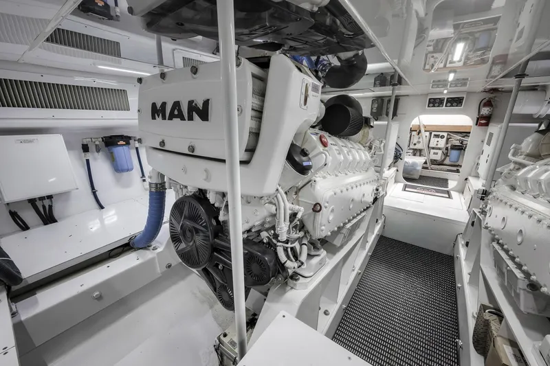 Slide: The Image of Engine room of 1999 Hines-Farley SPORTFISHERMAN with MAN engines, showcasing clean, organized layout. - 77