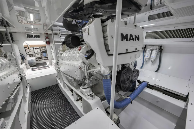 Slide: The Image of Engine room of a 1999 Hines-Farley SPORTFISHERMAN with MAN engines, showcasing clean, organized layout. - 78