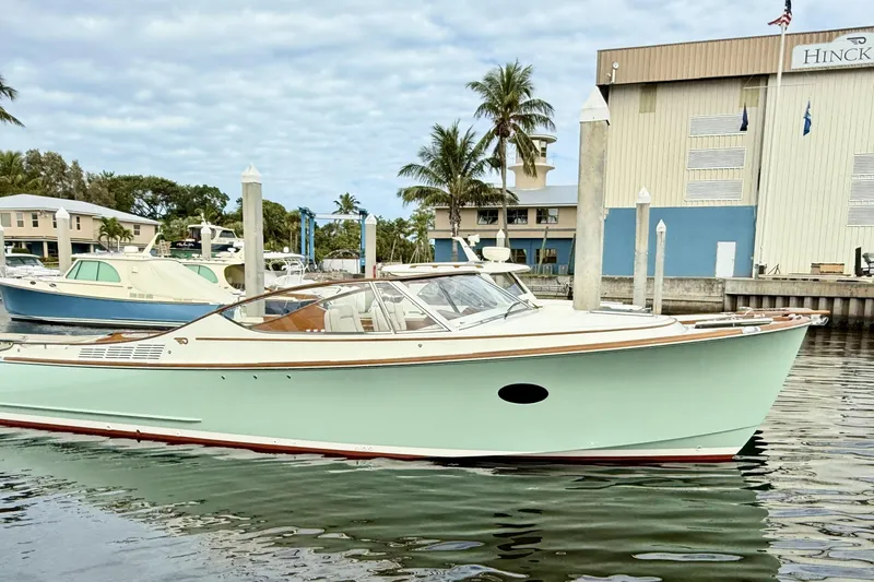 The Image of 2017 Hinckley Talaria 34R yacht docked at marina with palm trees and buildings. - 0